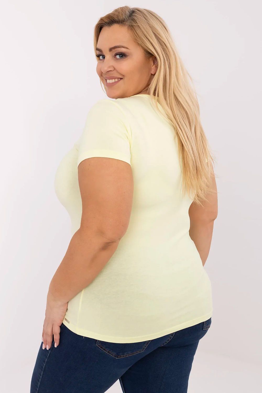 Stylish women's plus size t-shirt by Relevance, showcasing its elegant design paired with jeans, ideal for casual outings and social gatherings.