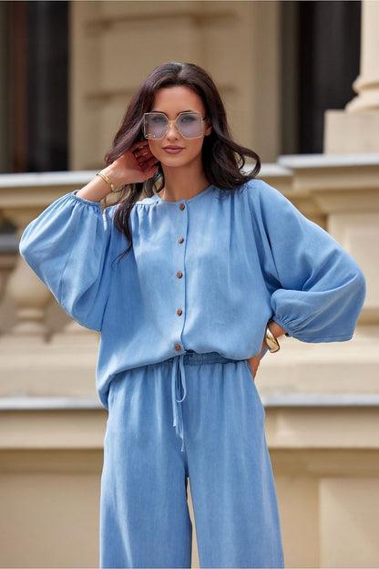 Model wearing the Roco Fashion long sleeve blouse, highlighting its luxurious fit and elegant button details, a versatile piece for modern wardrobes.