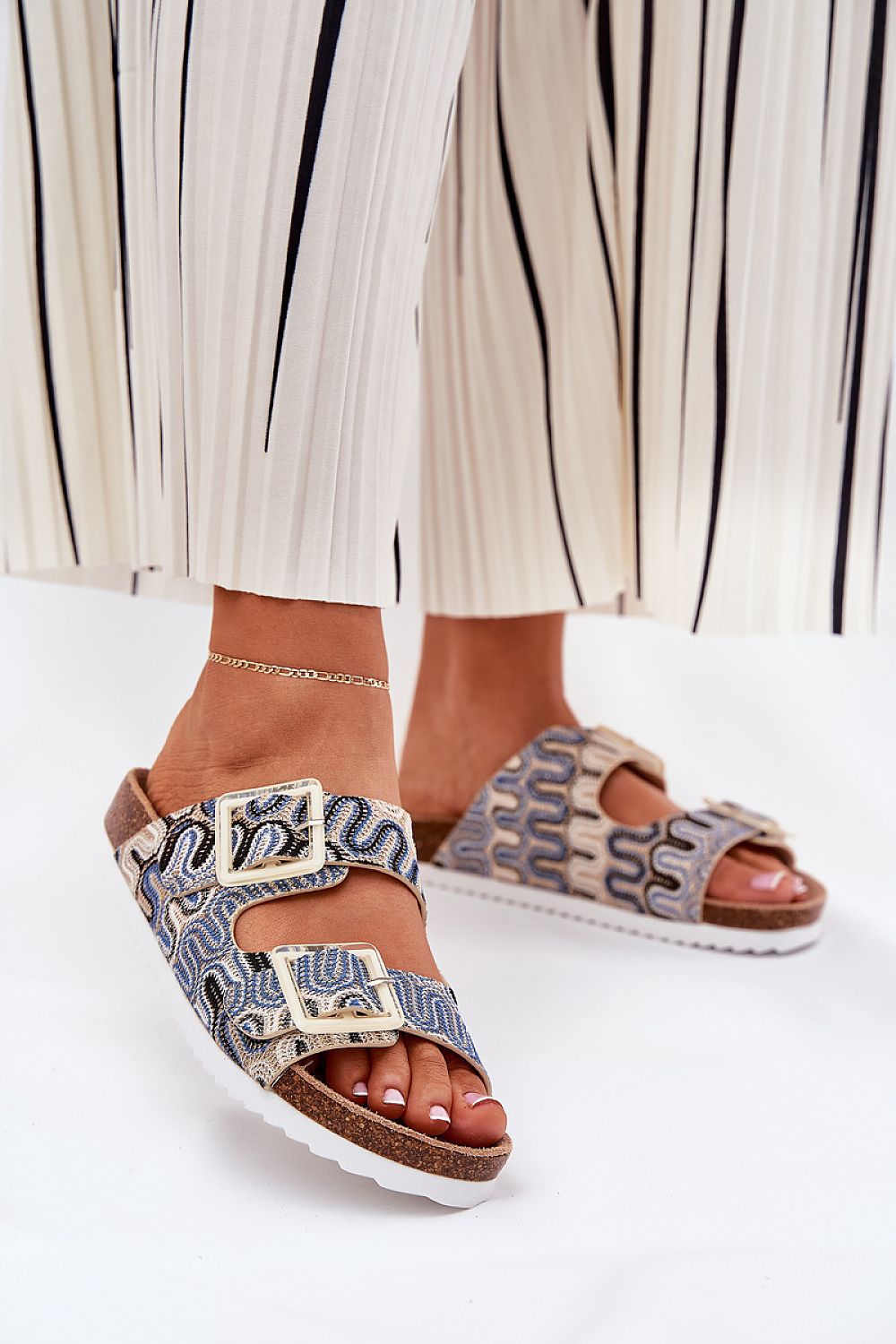Step in style luxury women's flip-flops, showcasing a unique design with a cork platform and textured straps, perfect for your summer wardrobe.