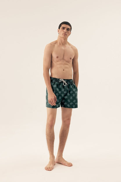 Close-up of Henderson Men's Elastic Waist Swim Trunks highlighting practical side pockets and elegant slits for enhanced movement.
