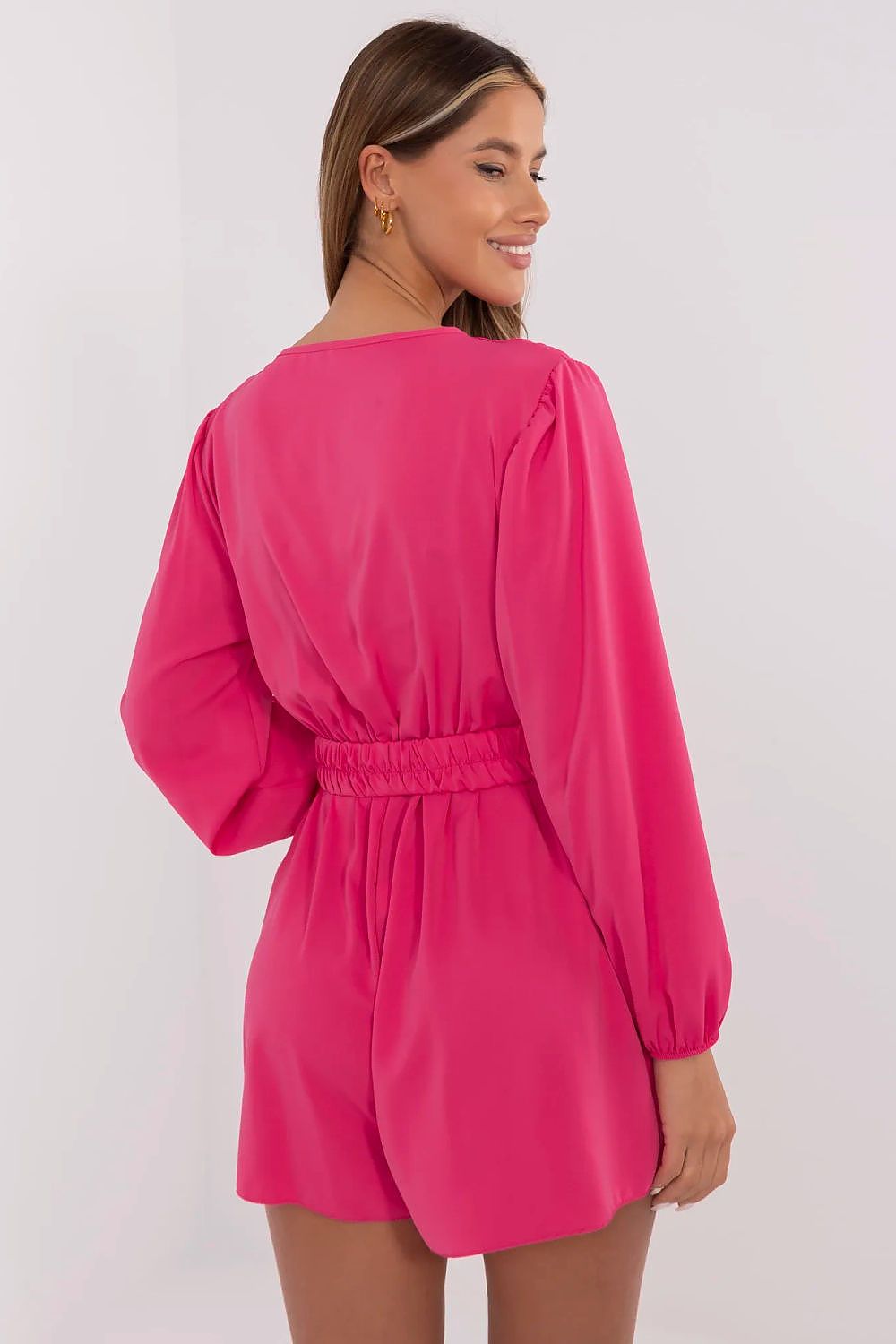 Elegant women’s jumpsuit by Italy Moda, highlighting the wrap neckline and long sleeves, designed for comfort and style in cooler weather.