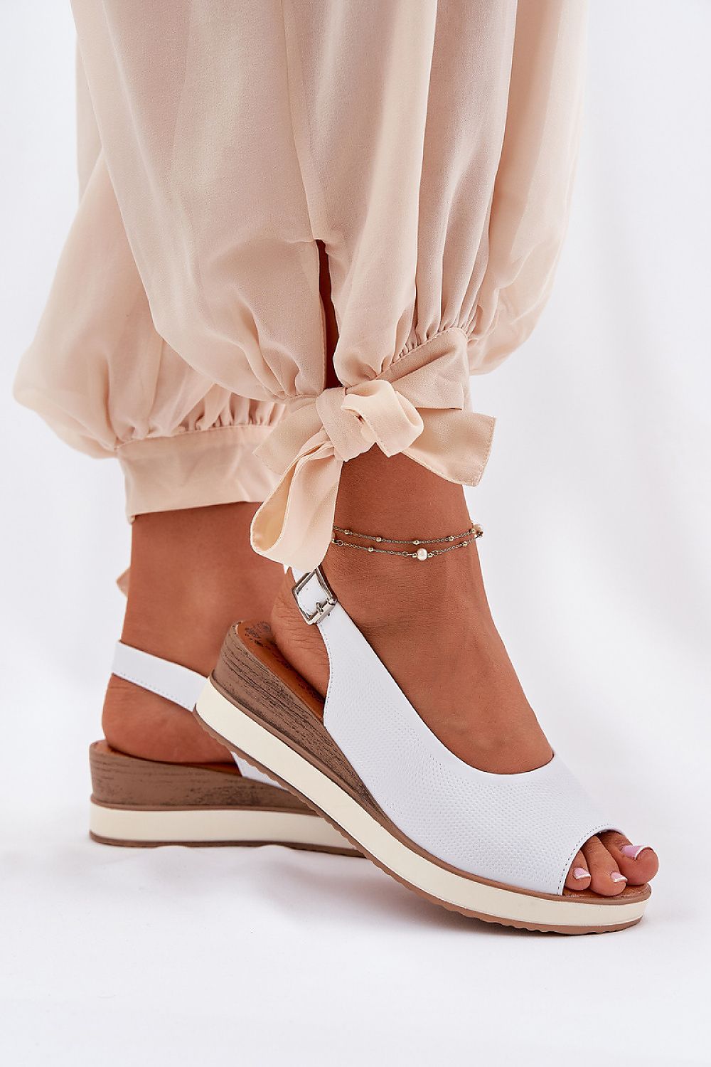 Luxurious women's wedge sandals from Step in Style, crafted from premium natural leather with an adjustable buckle strap for a perfect fit.