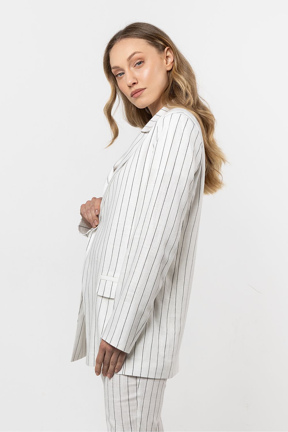 Close-up of the soft linen texture and delicate stripes of the awama blazer, exemplifying luxury and comfort.