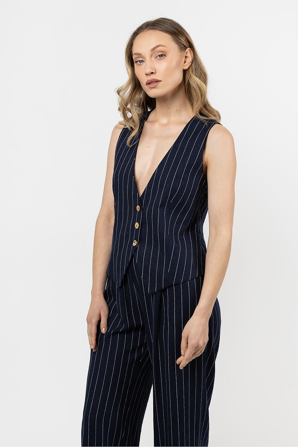 Stylish linen vest by awama in delicate stripes, perfect for sophisticated summer outfits, highlighting V-neck design and comfortable fit for women in sizes S to XL.