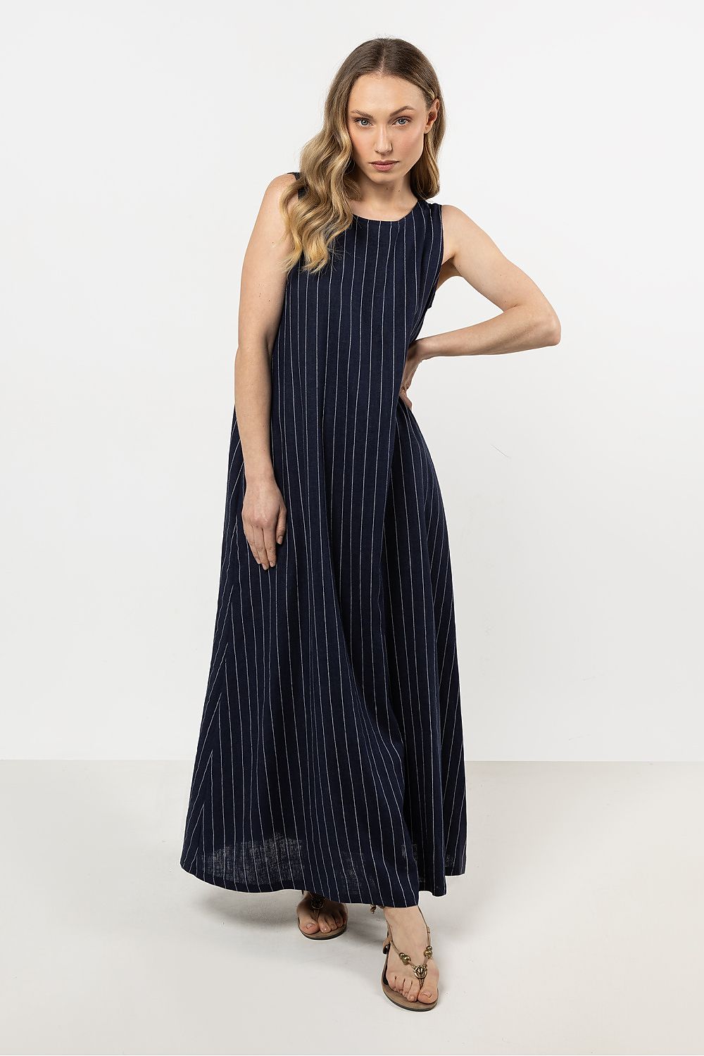 Elegant loose linen maxi dress with stripes by awama, featuring a boat neck and V-back design.