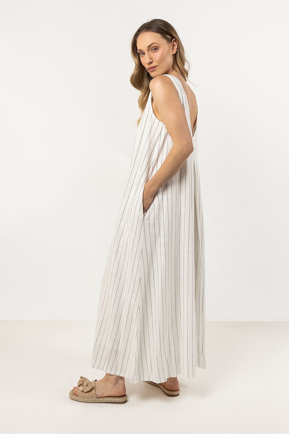 Breezy trapeze cut linen maxi dress by Awama in a stylish striped pattern, combining comfort and elegance for summer outings.