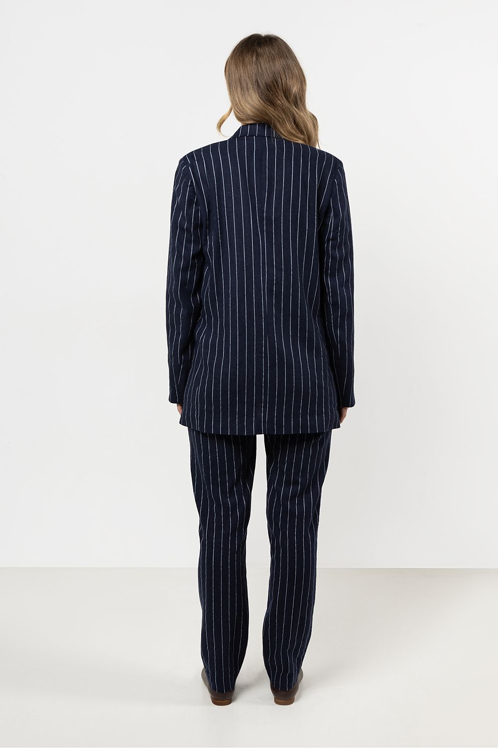 Elegant striped linen cigarette trousers for women, designed by Awama, showcasing luxury and comfort for all occasions.