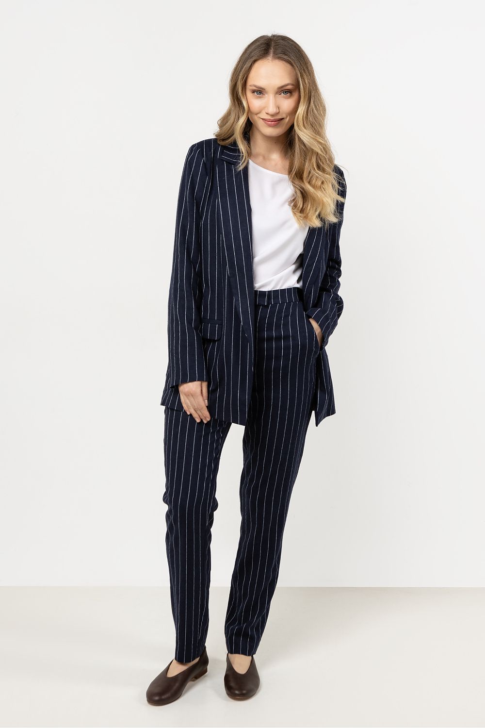 Chic close-up of Awama's elegant linen trousers, featuring sophisticated stripes and a tailored silhouette, perfect for stylish women.