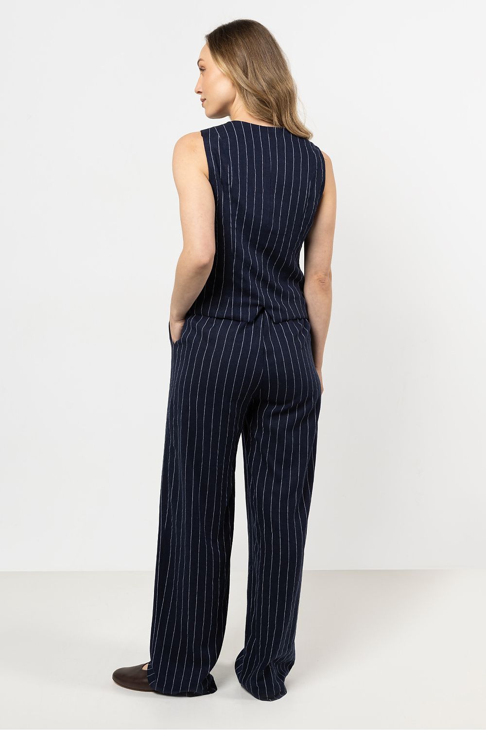 Close-up of awama's wide leg linen trousers in stripe design, highlighting the breathable fabric and sophisticated style.