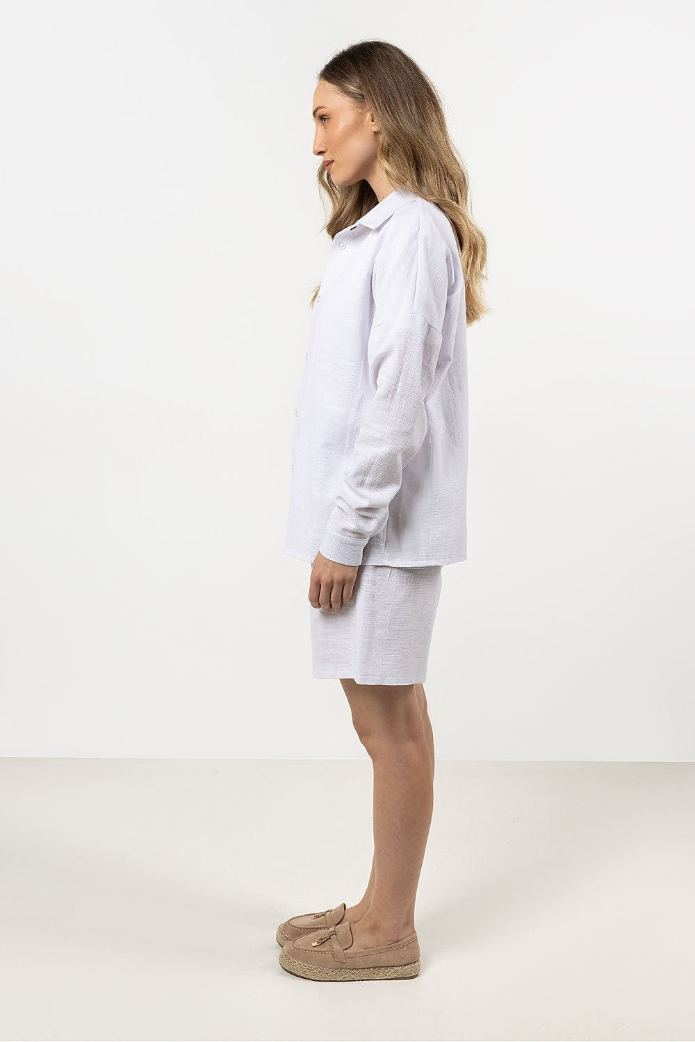 Elegant long sleeve Awama cotton shirt for women in soft white, featuring a contemporary stand-up collar and hidden button placket, perfect for luxurious everyday wear.