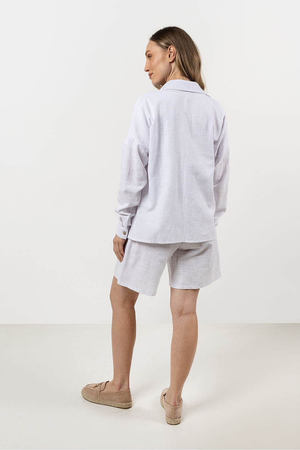 Stylish Awama cotton shirt for women displayed on a model, showcasing a flattering loose fit and breathable fabric, designed for comfort and elegance.