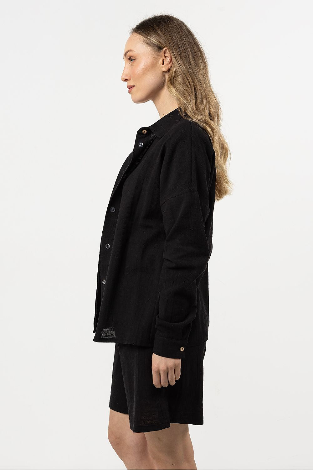 Versatile Awama women's cotton shirt styled with a skirt, exemplifying chic summer fashion and elegant comfort.