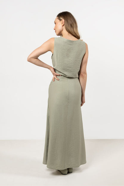 Awama's stylish flared rayon skirt draped elegantly on a model, illustrating its beautiful fit from waist to leg.