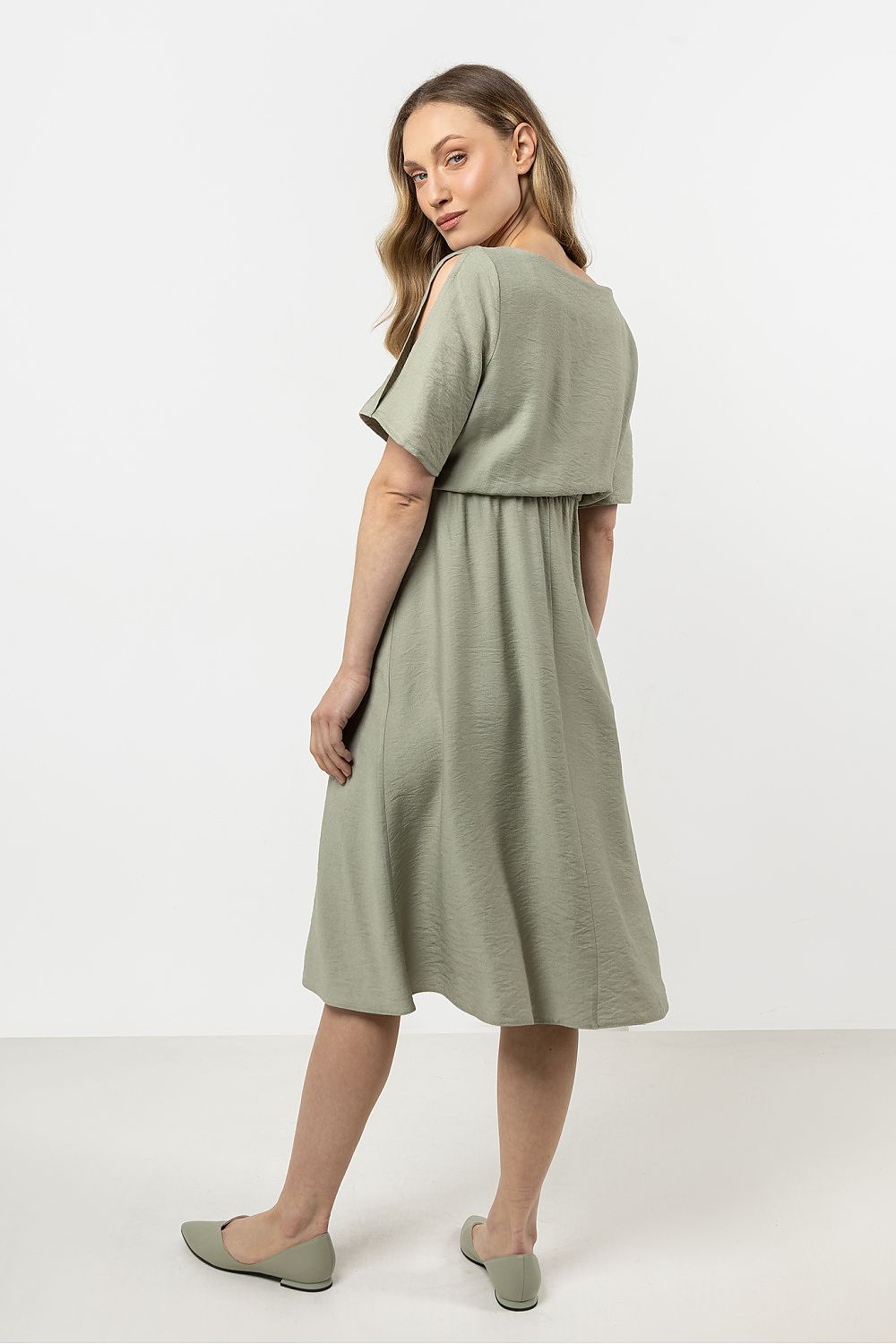 Close-up of the Awama daydress's intricate boat neckline and elegant short slashed sleeves, highlighting luxury and sophistication.