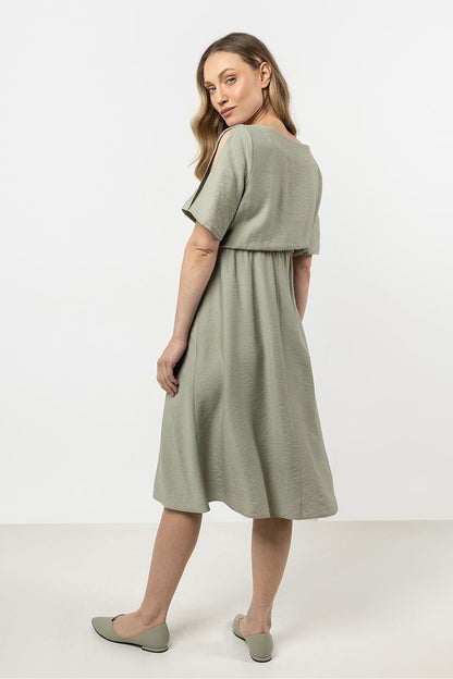 Close-up of the Awama daydress's intricate boat neckline and elegant short slashed sleeves, highlighting luxury and sophistication.