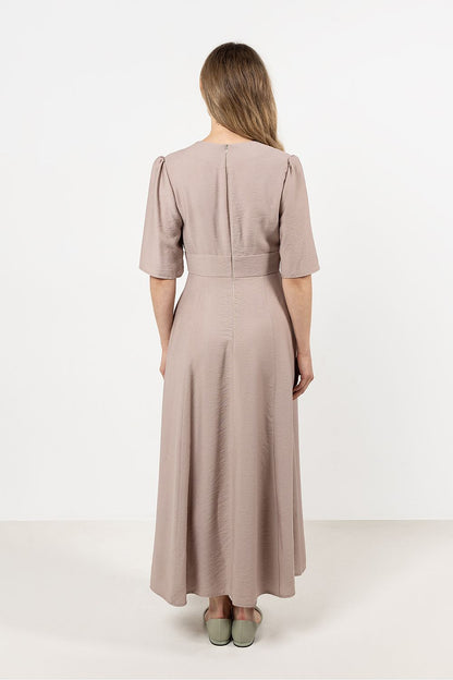 Awama Daydress displayed on a model, highlighting the flattering fitted cut and waist-defining belt, perfect for luxurious comfort.