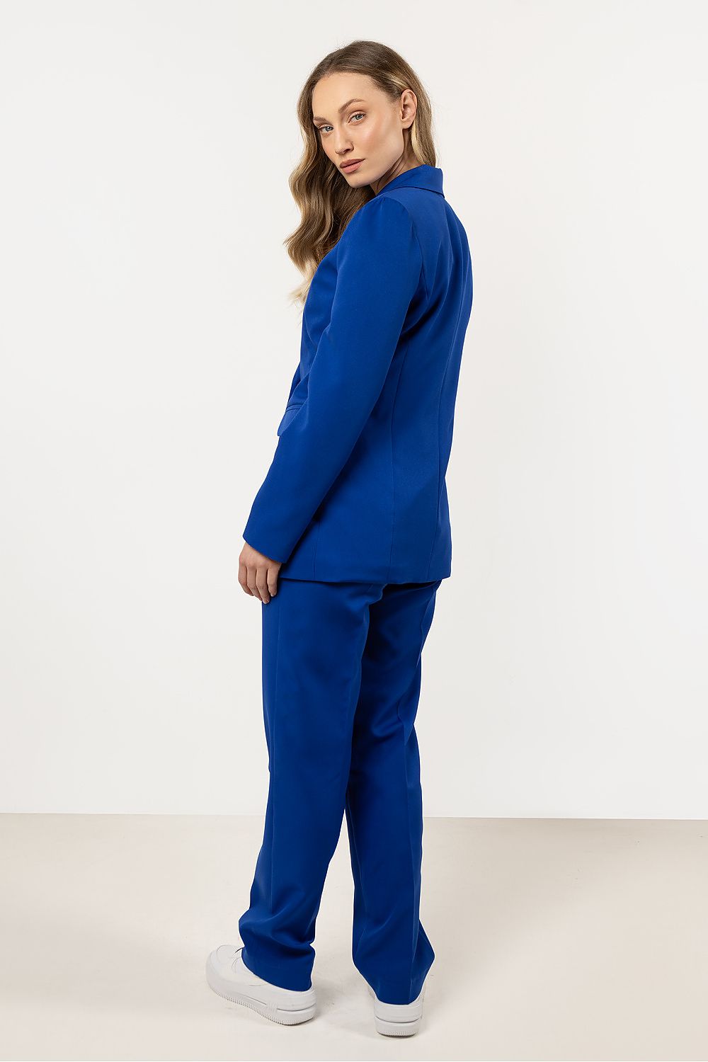 Complete look with Awama's fitted blazer styled elegantly with matching trousers, exemplifying a polished women's suit for special events and professional settings.