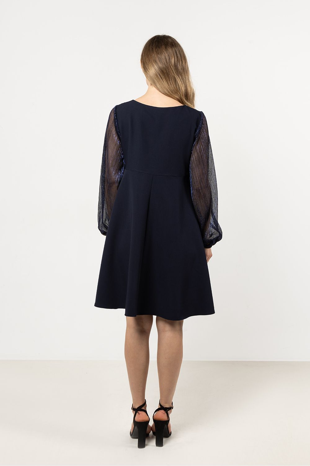 Model wearing the luxury evening dress by Awama, highlighting its flattering trapeze silhouette and perfect fit.