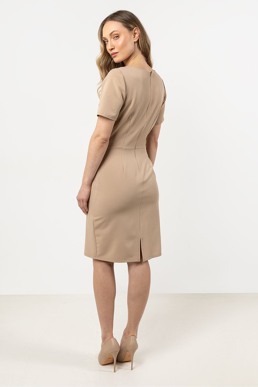 Versatile Awama pencil dress with asymmetrical hem, ideal for various occasions, featuring a classic neckline and stylish decorative detail.