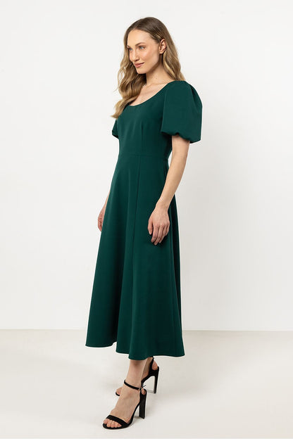 Elegant Awama Daydress featuring a deep neckline and flared bottom, showcasing luxurious comfort and sophisticated style.