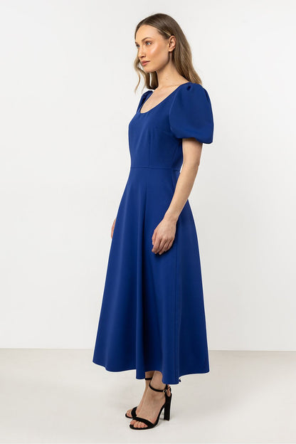 Full-length view of the Elegant Awama Daydress with deep neckline, flared bottom and a sophisticated character, ideal for luxury events.