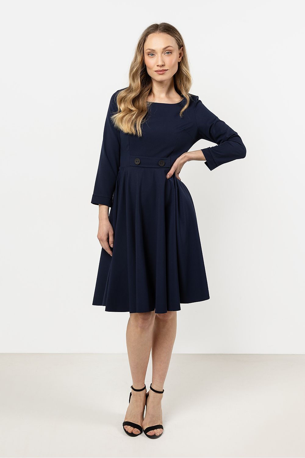 Elegant Flared Daydress by Awama with boat neckline and decorative buttons, showcasing a flattering flared silhouette for a luxurious look.