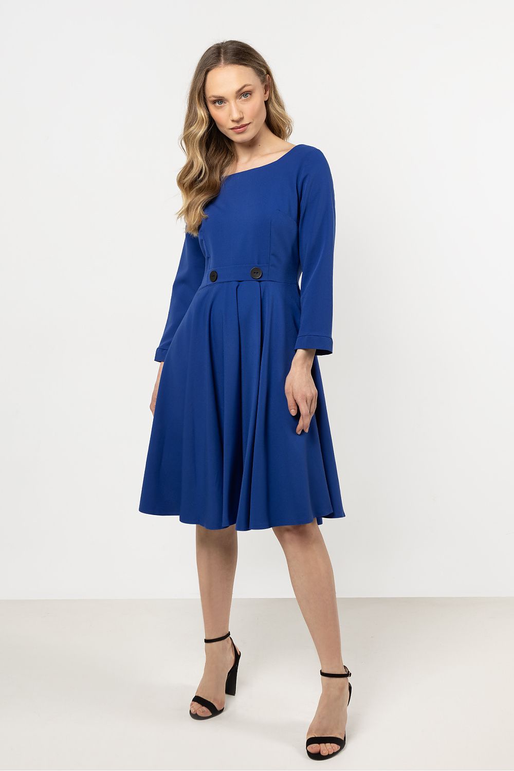 Stylish woman modelling the Elegant Flared Daydress by Awama, highlighting the flattering flared silhouette and elegance of the design.