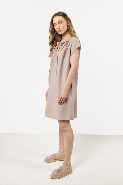 Awama's luxurious loose-fit daydress featuring a feminine gathering at the neckline, designed for comfort and elegance, ideal for a chic day out.
