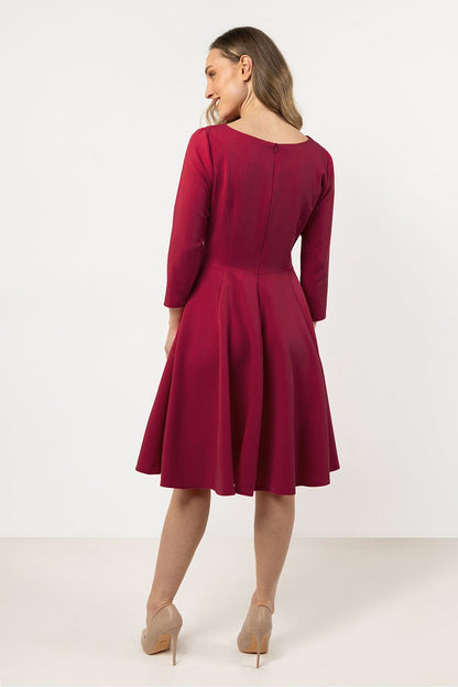 Model wearing Awama flared daydress, highlighting the classic silhouette and 3/4 sleeves, perfect for special outings.