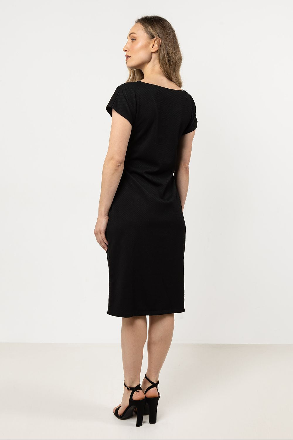 Model showcasing the elegant Awama Daydress in a classic silhouette, styled beautifully for special occasions.