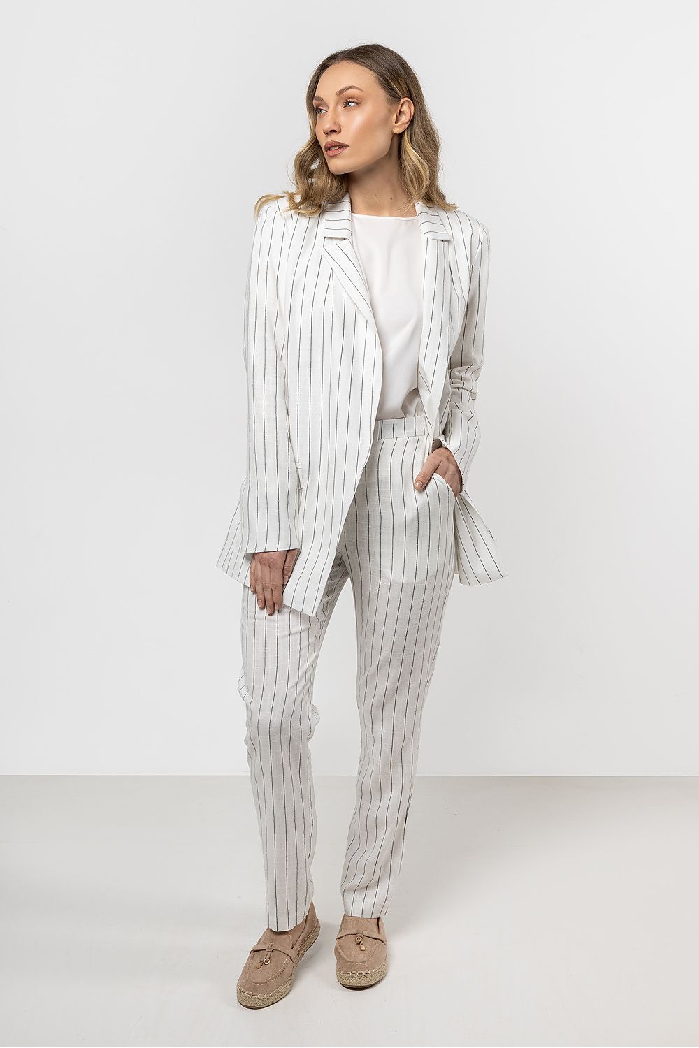 Close-up of the luxurious linen texture of the striped cigarette trousers for women by awama, highlighting the soft fabric and refined detailing.