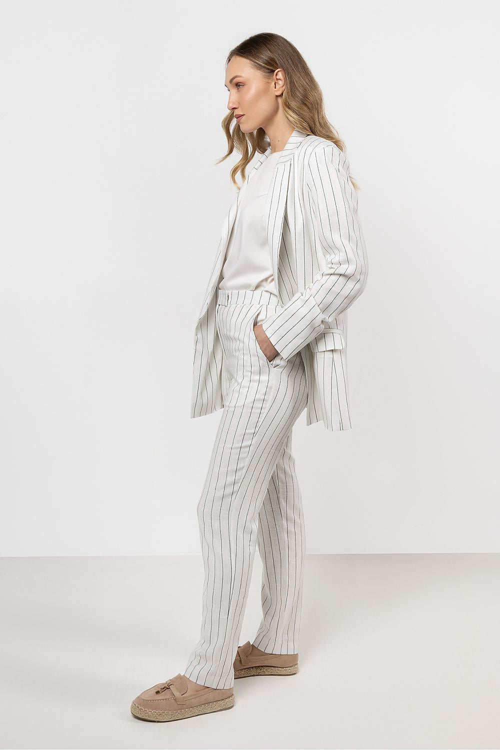 Stylish look featuring women in elegant striped linen cigarette trousers by awama, perfect for summer styling with a vest or blazer.