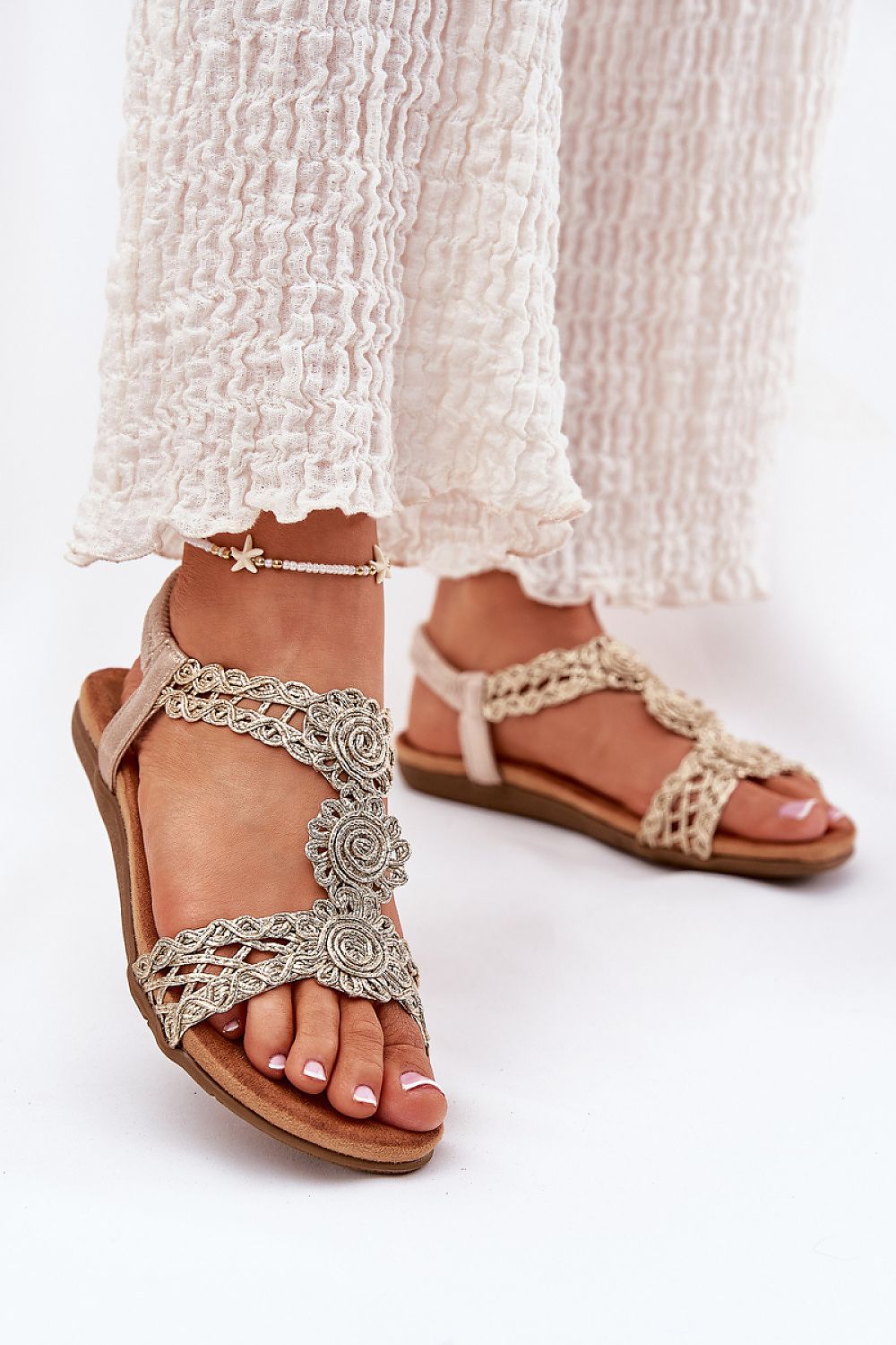 Elegant flat women's sandals featuring braided straps, designed for comfort by Step in style, perfect for summer.