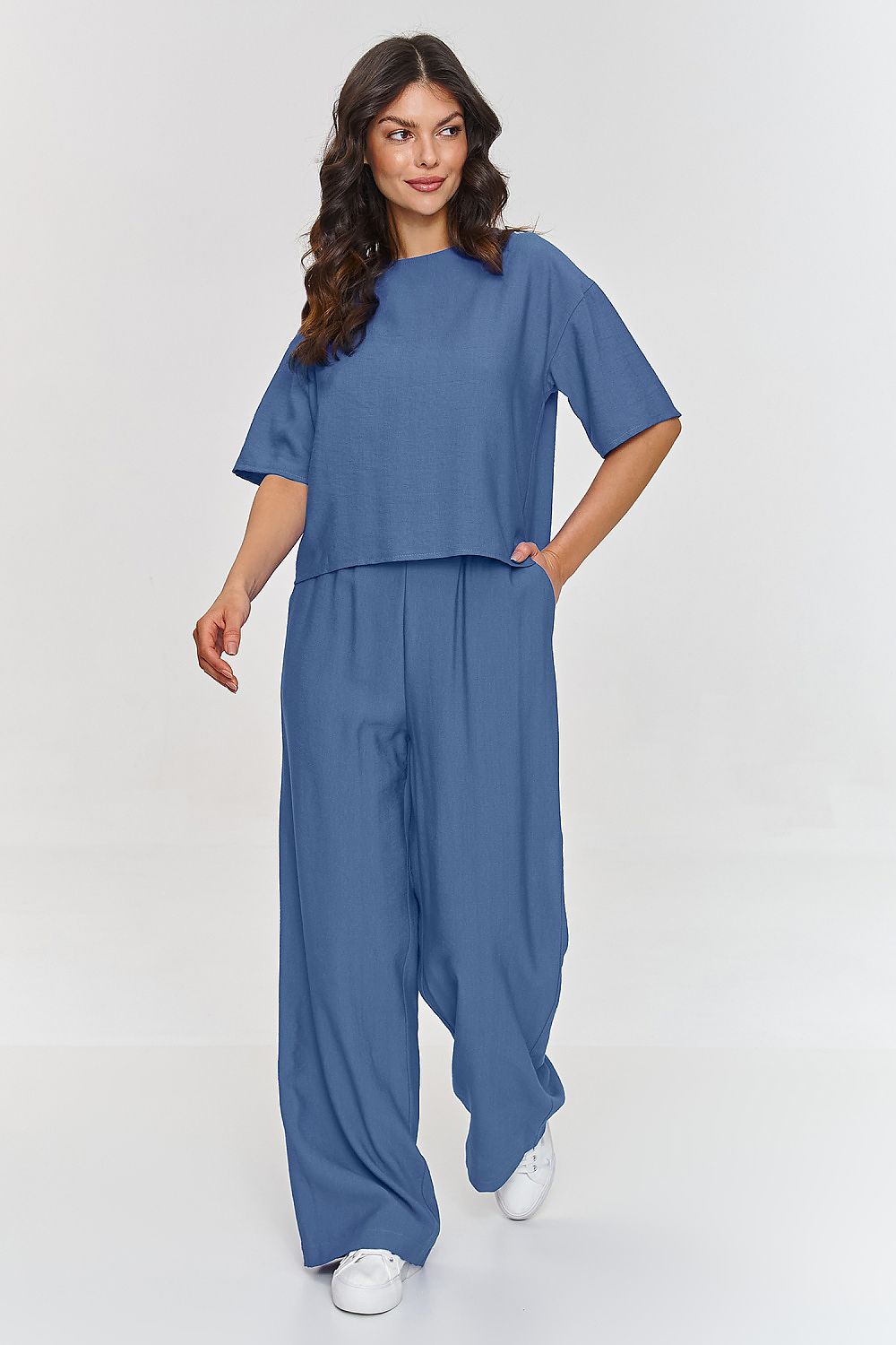 Model wearing the elegant Makadamia 2-Piece Blouse and Wide Leg Pants Set, showcasing its sophisticated silhouette and timeless appeal, suitable for both formal and casual occasions.