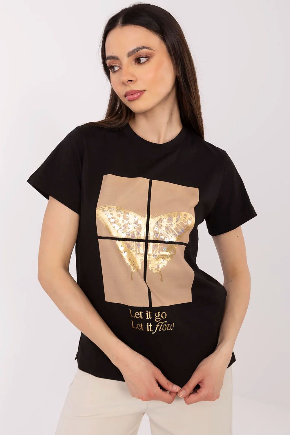 Model wearing a luxury women's t-shirt with butterfly sequin detail from Factory Price, styled for a chic everyday look.