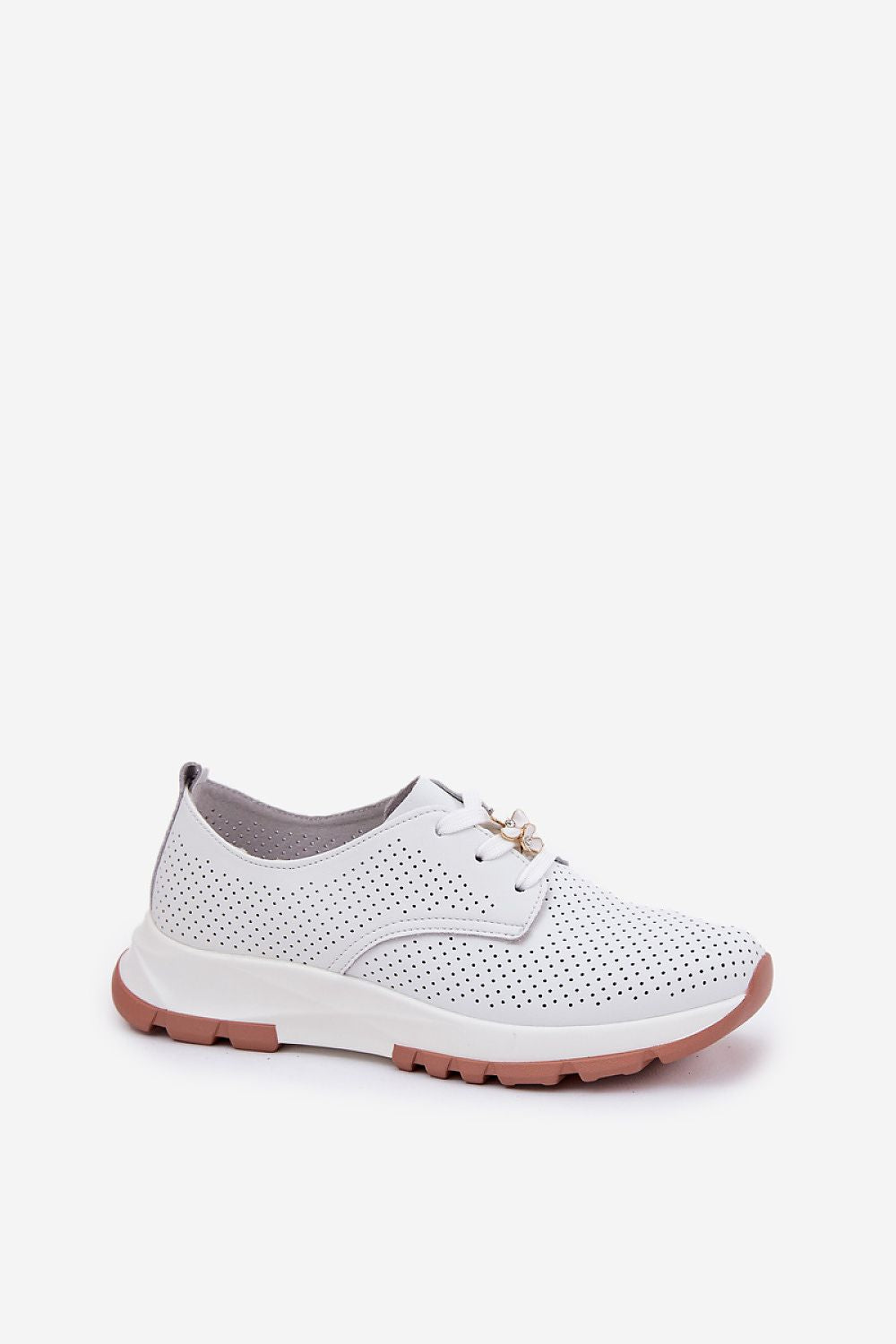 Close-up of flower-shaped charms on natural leather women’s sports-style half shoes by Step in Style, showcasing luxury and attention to detail.