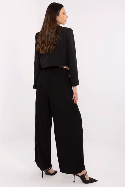 Stylish outfit styling with Sublevel's luxury high-waist wide-leg trousers, emphasizing modern elegance and comfort with a chic waist tie.