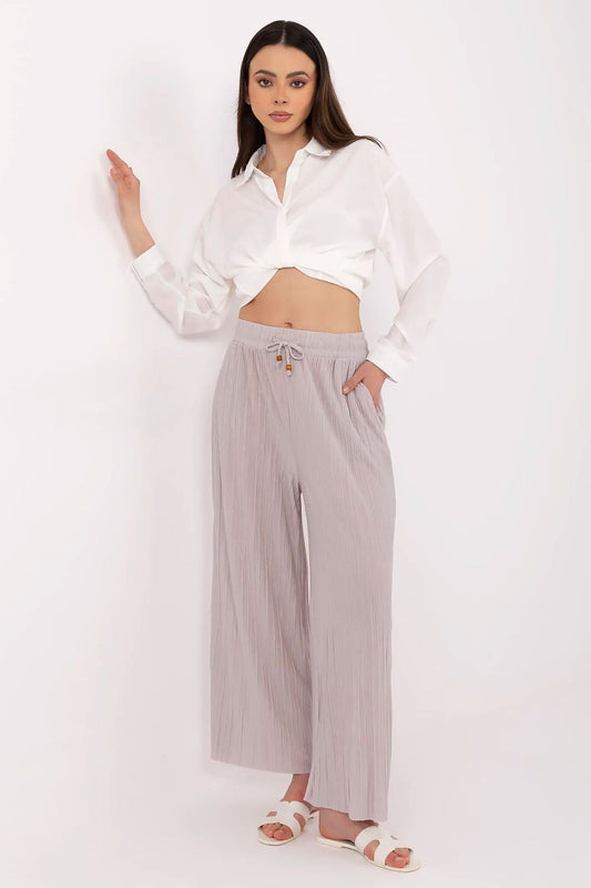 Stylish women's high-waist trousers by Sublevel, featuring a tie waist and practical pockets, crafted from a luxurious viscose and polyester blend for ultimate comfort. Available in sizes S to XL, these trousers embody modern elegance with a flattering silhouette, perfect for both casual outings and professional occasions.