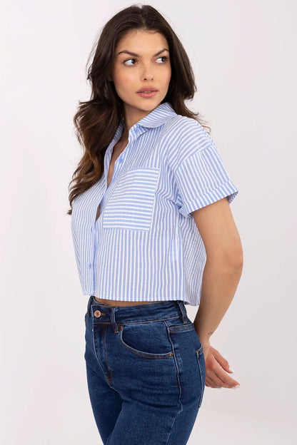 Model wearing NM's luxury striped cotton short sleeve shirt, perfect for warmer days, paired effortlessly with jeans and a skirt.