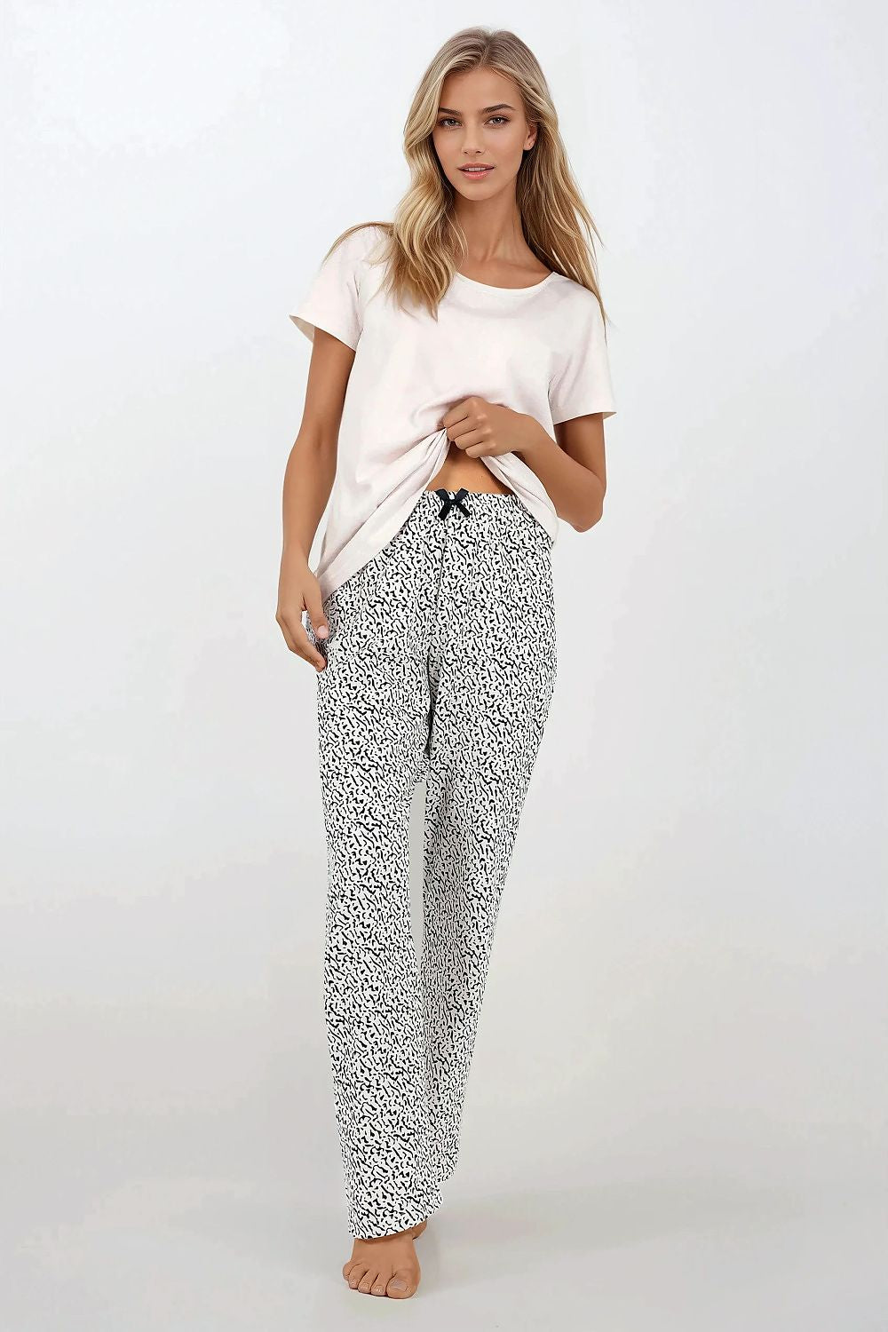 Luxurious Women's 2-Piece Cotton Pajamas Set by Momenti Per Me, showcasing a stylish short-sleeved top and long pants, perfect for comfort and elegance in any home setting.