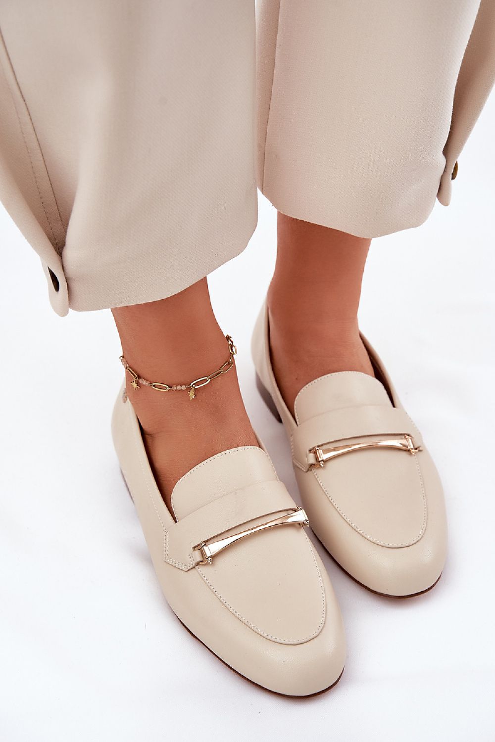 Stylish Maciejka natural leather loafers, accentuated with golden detailing, designed for chic and casual occasions.