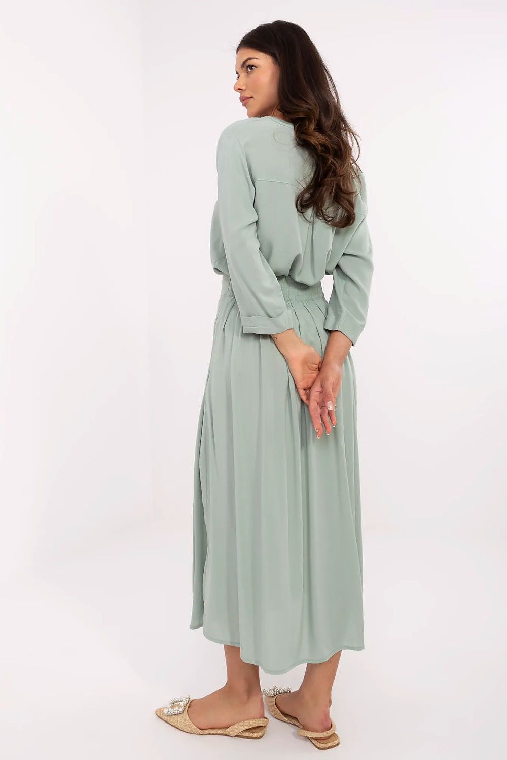 Elegant pleated midi skirt in eco viscose by Sublevel, featuring stylish decorative buttons and a comfortable fit ideal for everyday and work wear.
