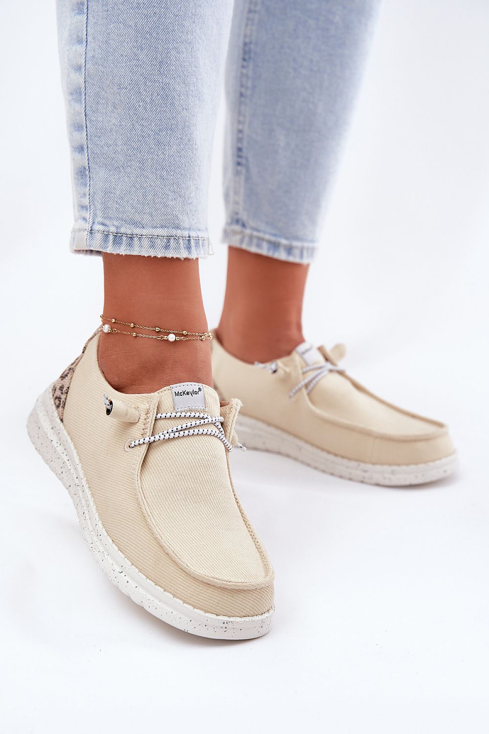 Stylish women's slip-on shoes from Step in Style featuring fashionable rubber bands resembling shoelaces, ideal for everyday chic outfits.