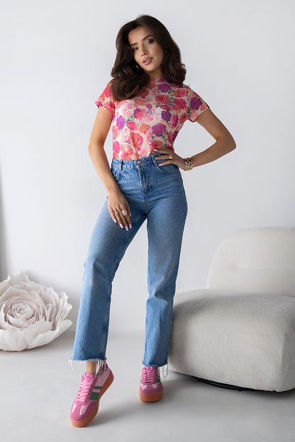 Model wearing LaBalancia tulle blouse, demonstrating its flattering silhouette and feminine charm with a vibrant chic print.