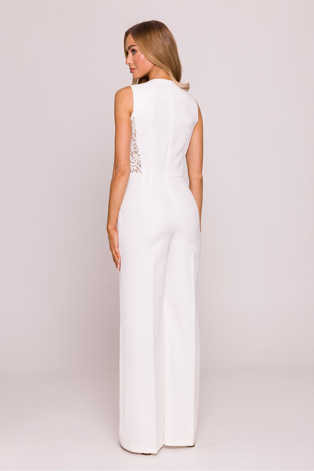 Model wearing the Moe jumpsuit, perfectly suited for evening outings and formal events, featuring wide long legs and a high round neckline.