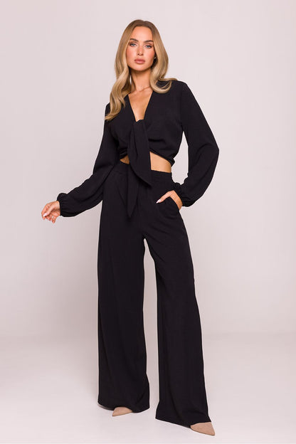 Model wearing Moe Women's Lightweight Crepe Trousers, demonstrating the perfect fit and contemporary style for everyday elegance.