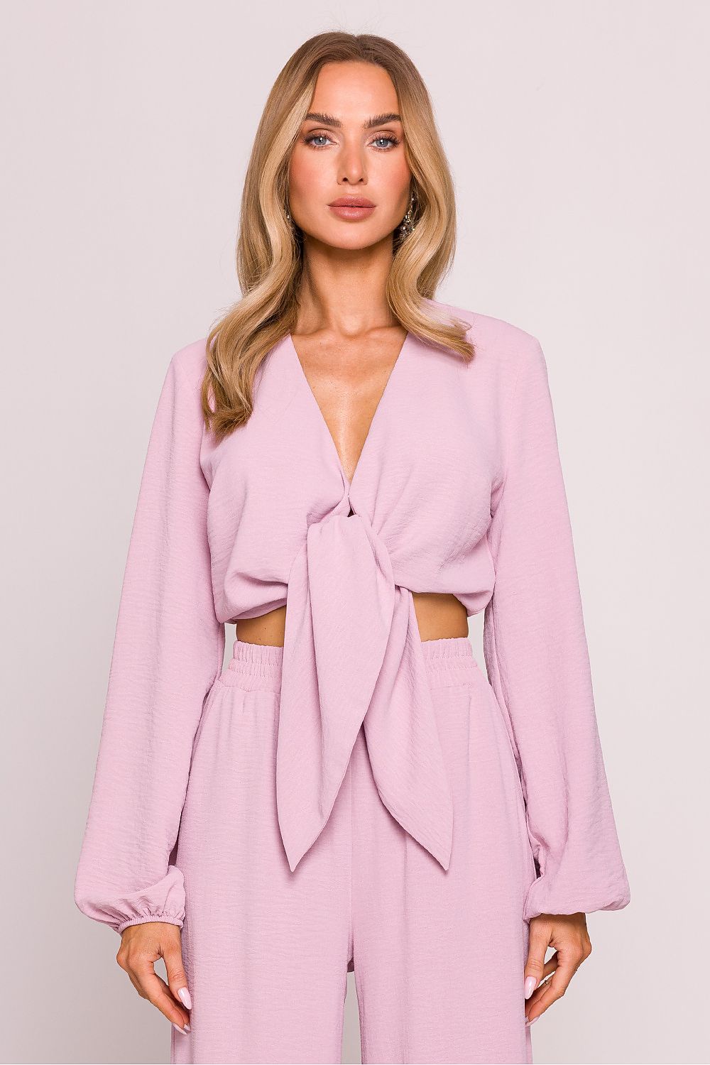 Flat lay of Moe's Luxury Crepe Crop Blouse on a soft surface, displaying its lightweight crepe fabric and elegant design.