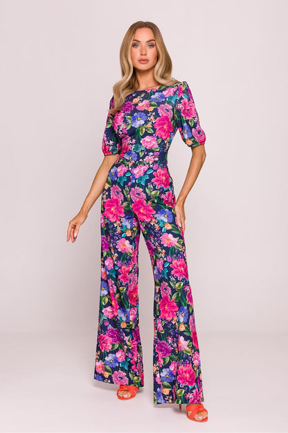 Back view of the floral print jumpsuit by Moe, featuring a stylish cut-out detail and button accents, epitomising luxury and sophistication.