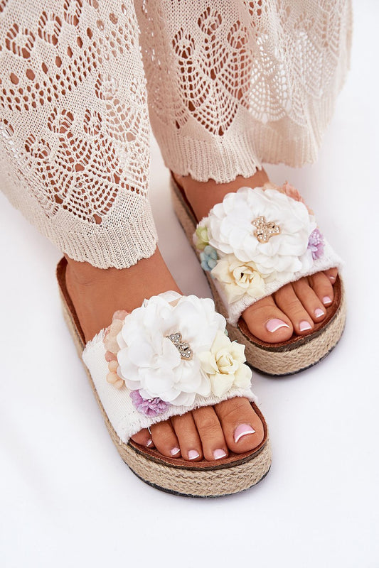 Luxury women's flip-flops by Step in Style featuring a jute braided platform, adorned with floral designs and a cute teddy bear pin, ideal for summer elegance.