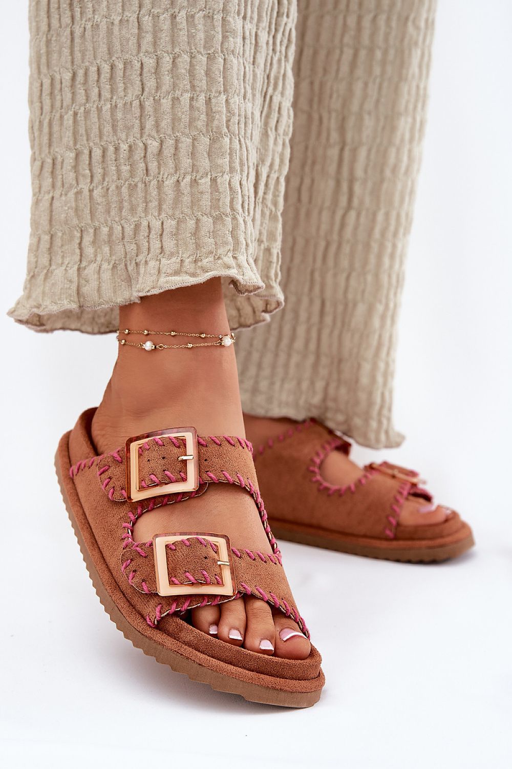 Luxury women's suede flip-flops from Step in Style featuring elegant eye-catching buckles and a chic design.